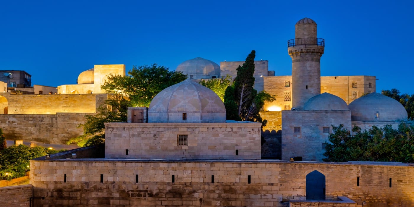The intricate stone architecture of the Shirvanshahs Palace complex in Baku, Azerbaijan, featuring various buildings, courtyards, and a prominent Divankhana